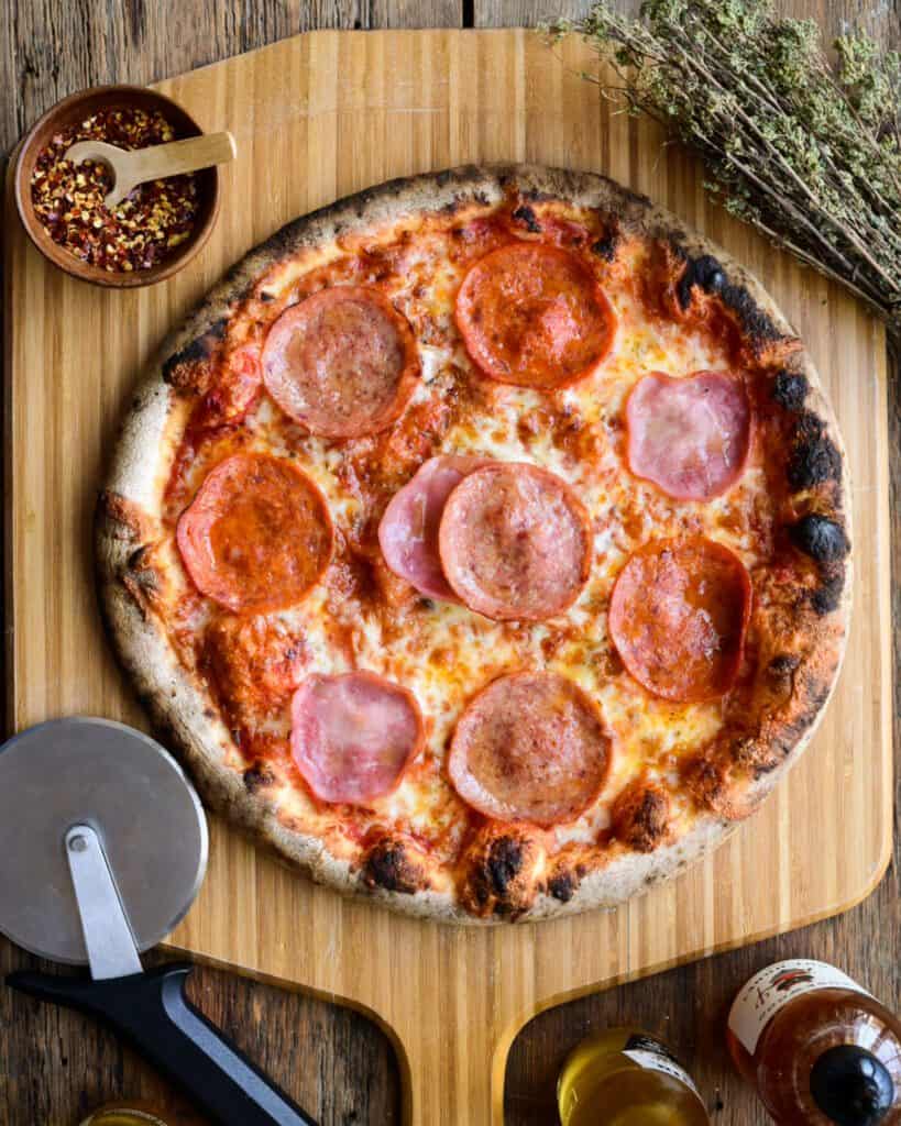 A homemade meat lover's pizza with salami, pepperoni, and ham.