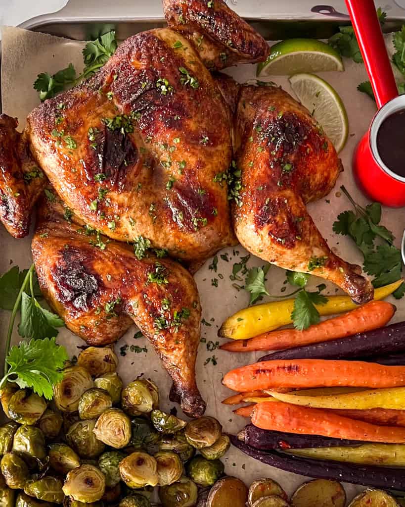 A spatchcock chicken served with vegetables.