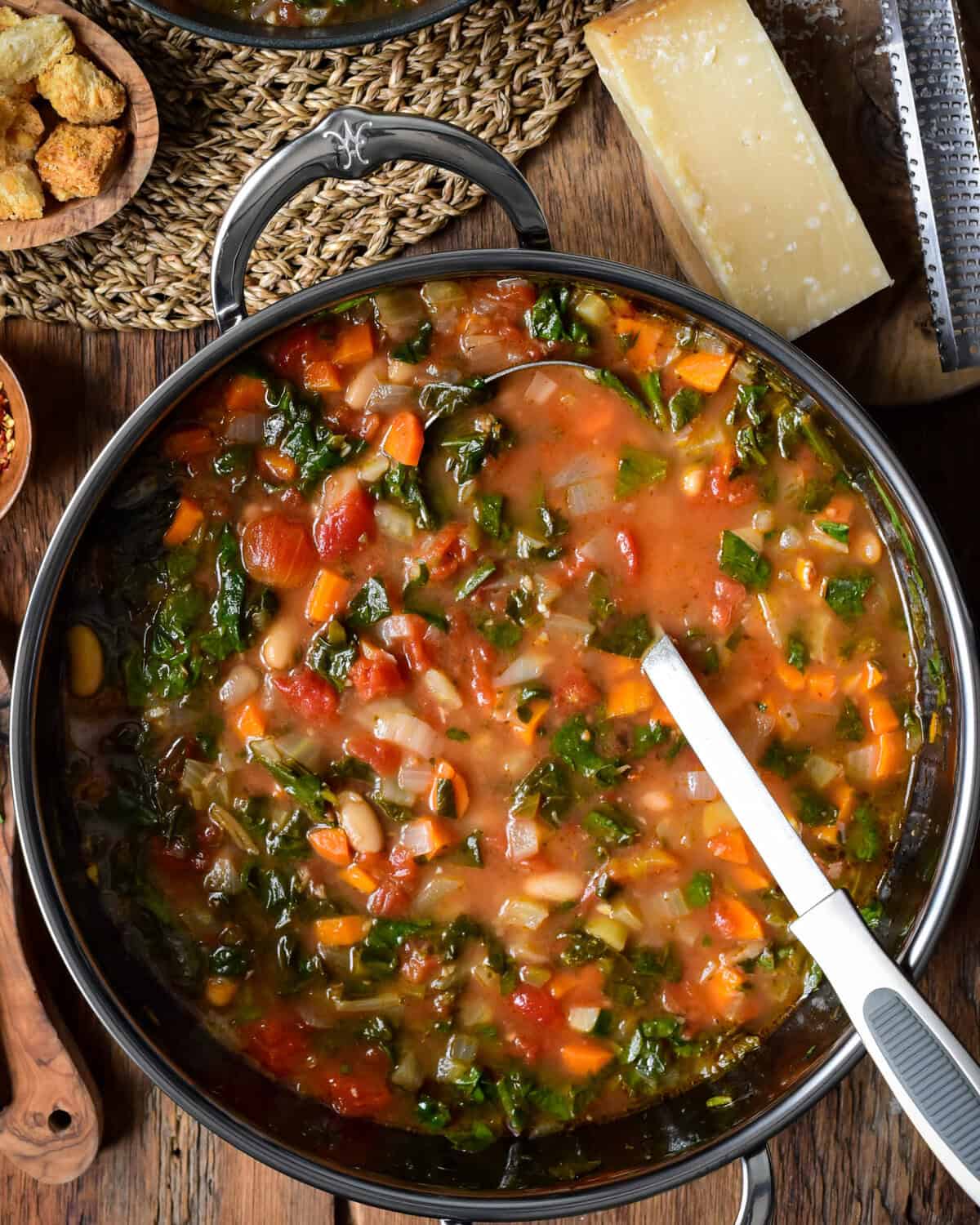 A large pot of a Tuscan-inspired white bean and spinach soup.