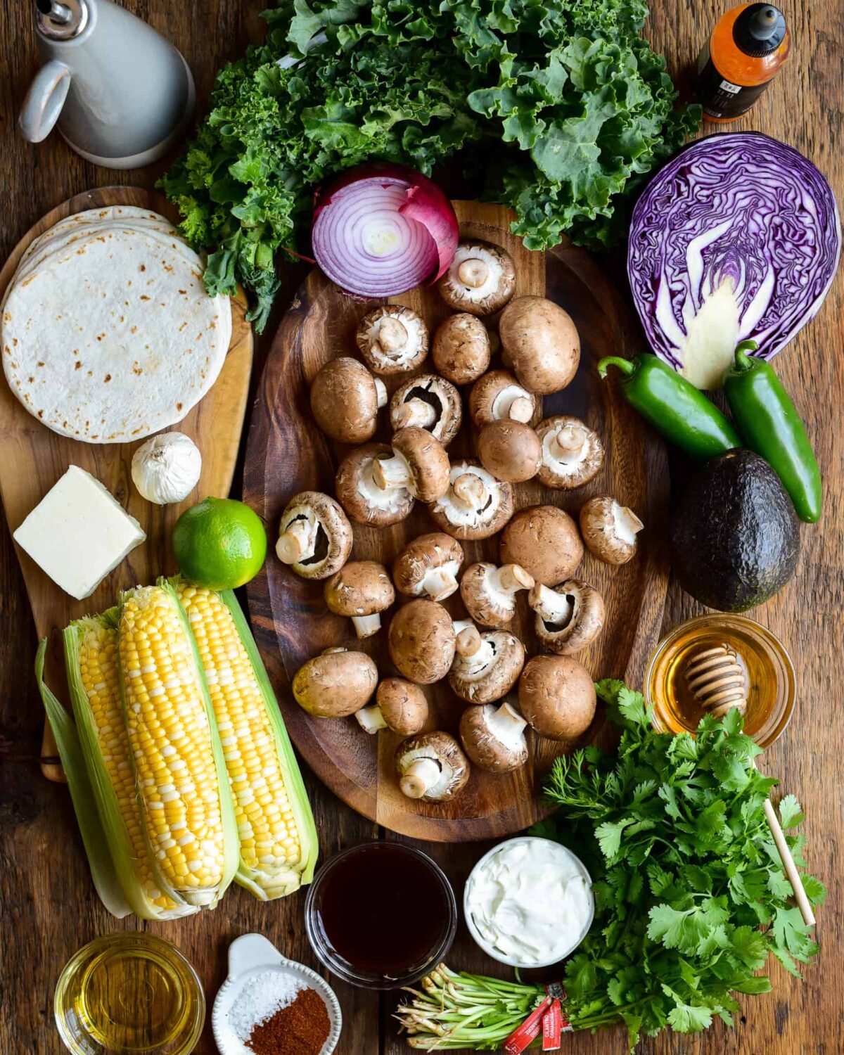 A cremini mushroom image surrounded with ingredients to make mushroom tacos.