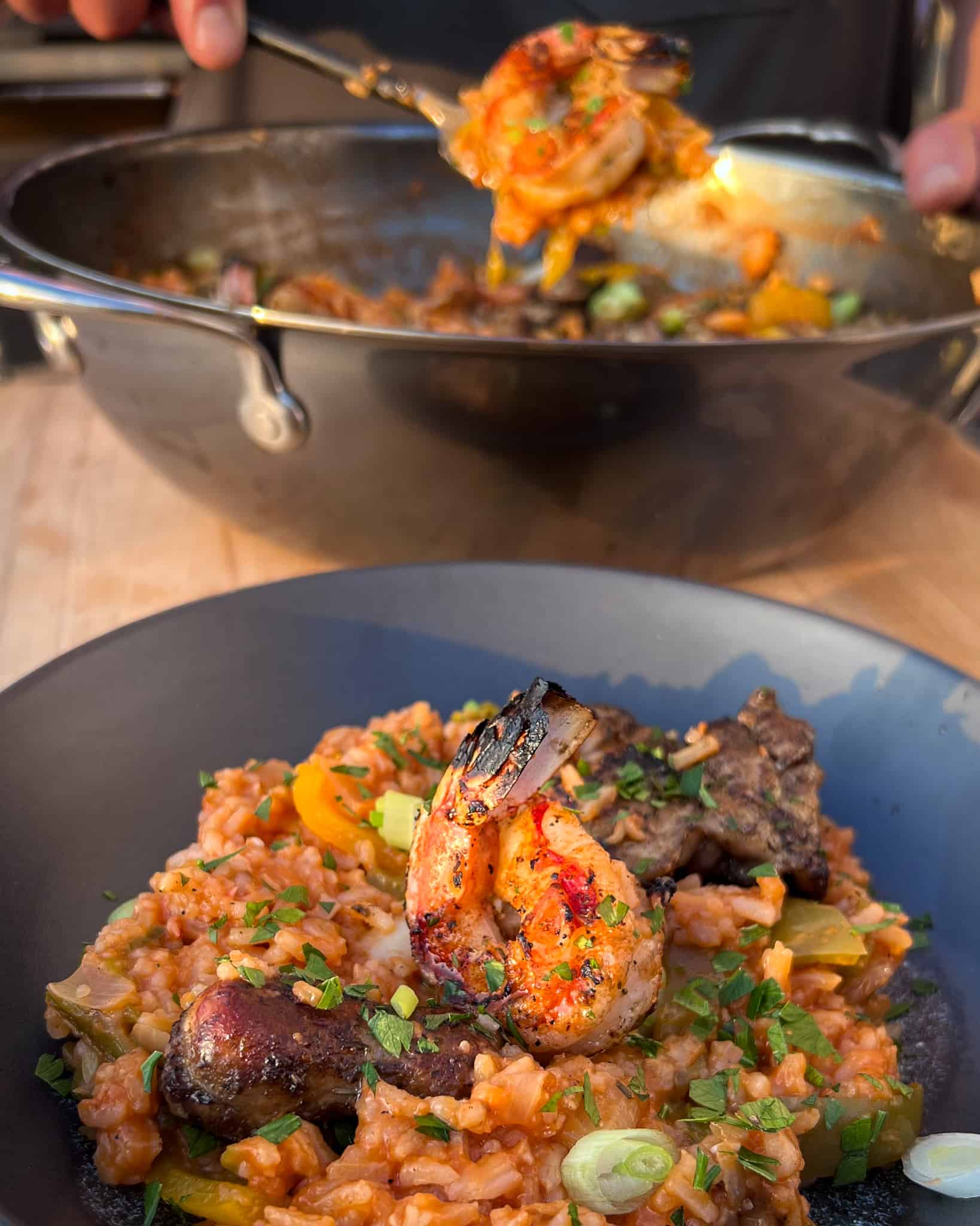 A bowl of grilled jambalaya with grilled shrimp, chicken and sausage.