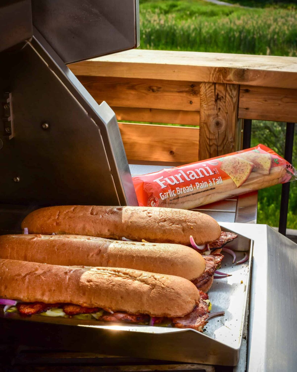 Three Cuban sandwiches made on garlic bread loaves.