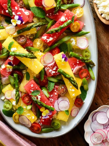 A plater of compressed watermelon salad with sous-vide asparagus.