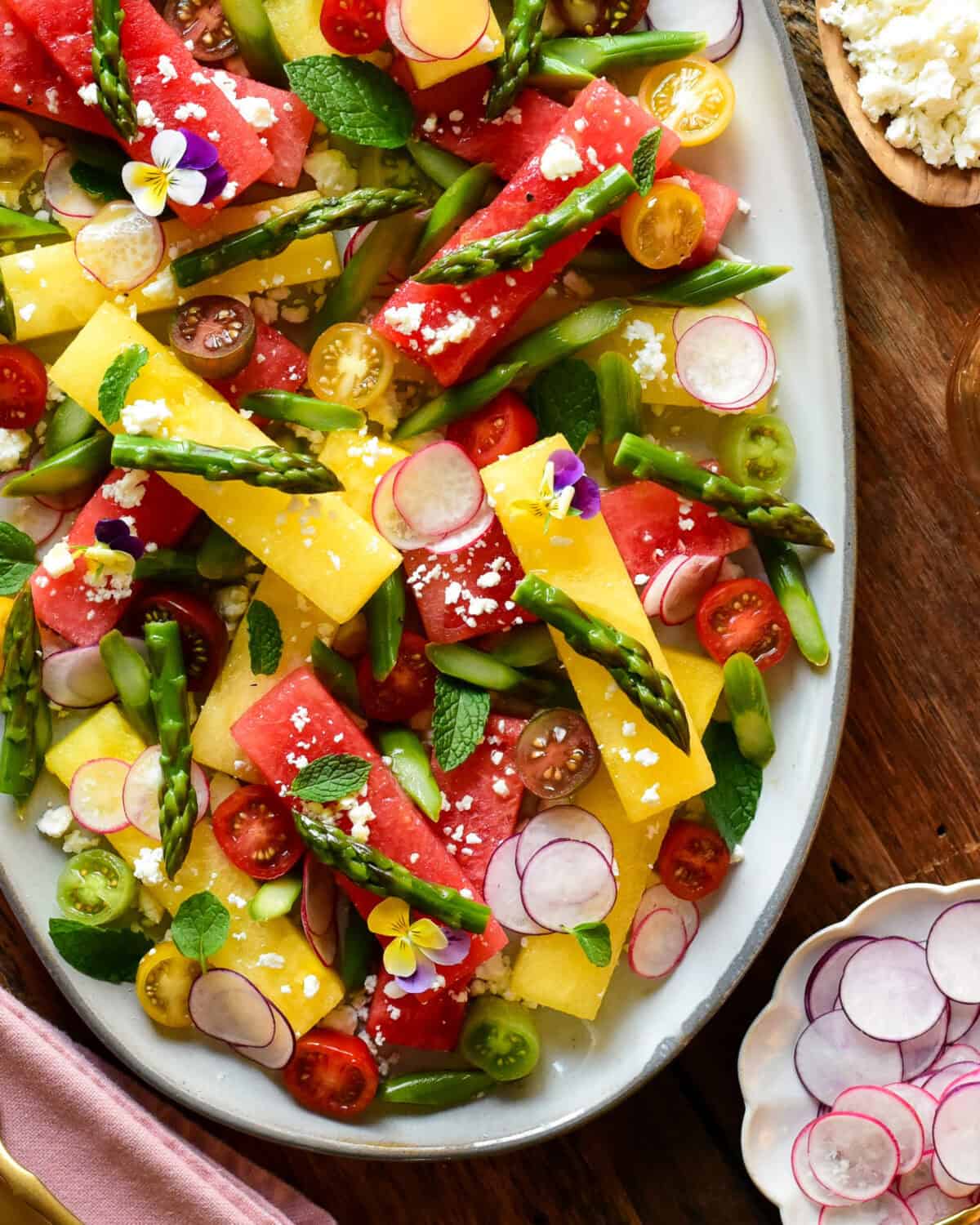 A plater of compressed watermelon salad with sous-vide asparagus.