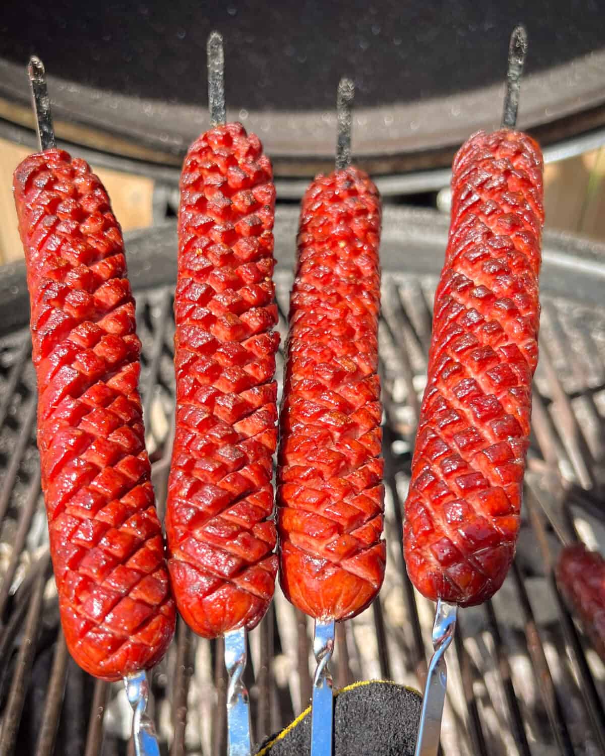 Four crosshatched beef smokies on skewers. When grilled they transform into delightful "corn-like" blossoms.