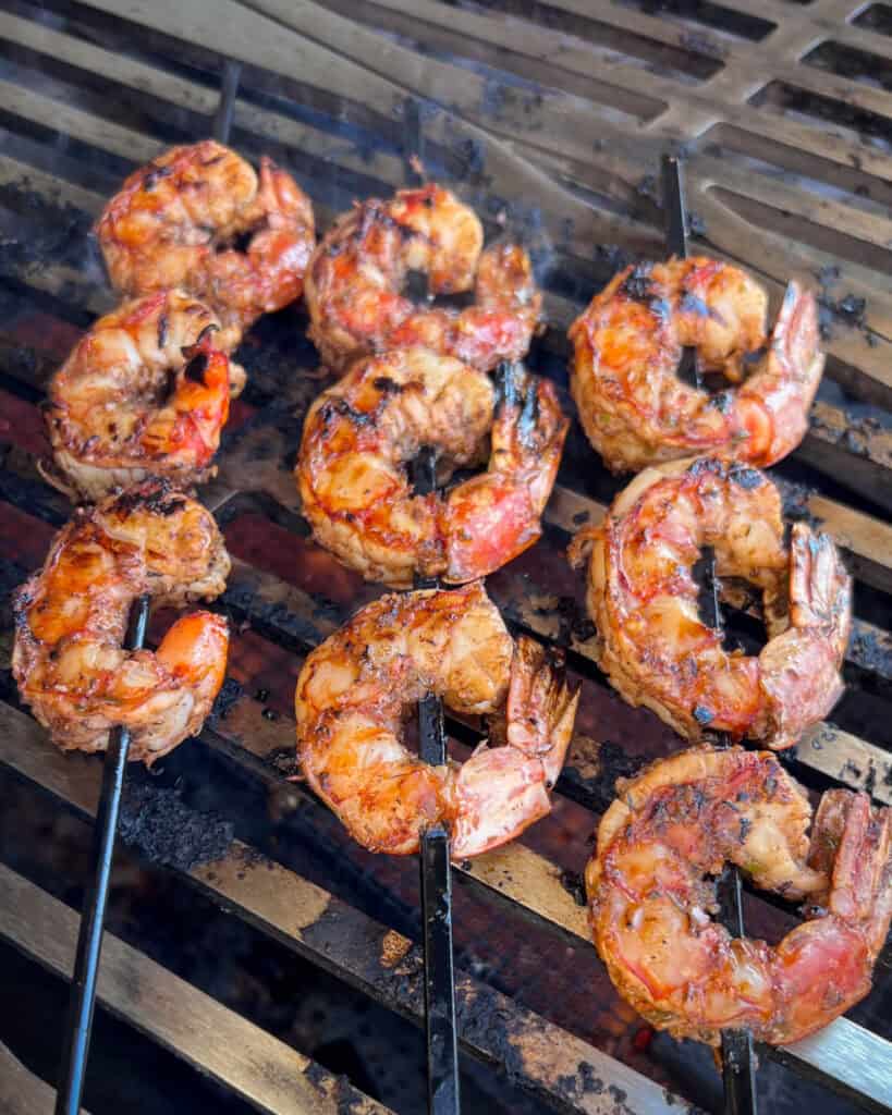 Three grilled jerk shrimp skewers.