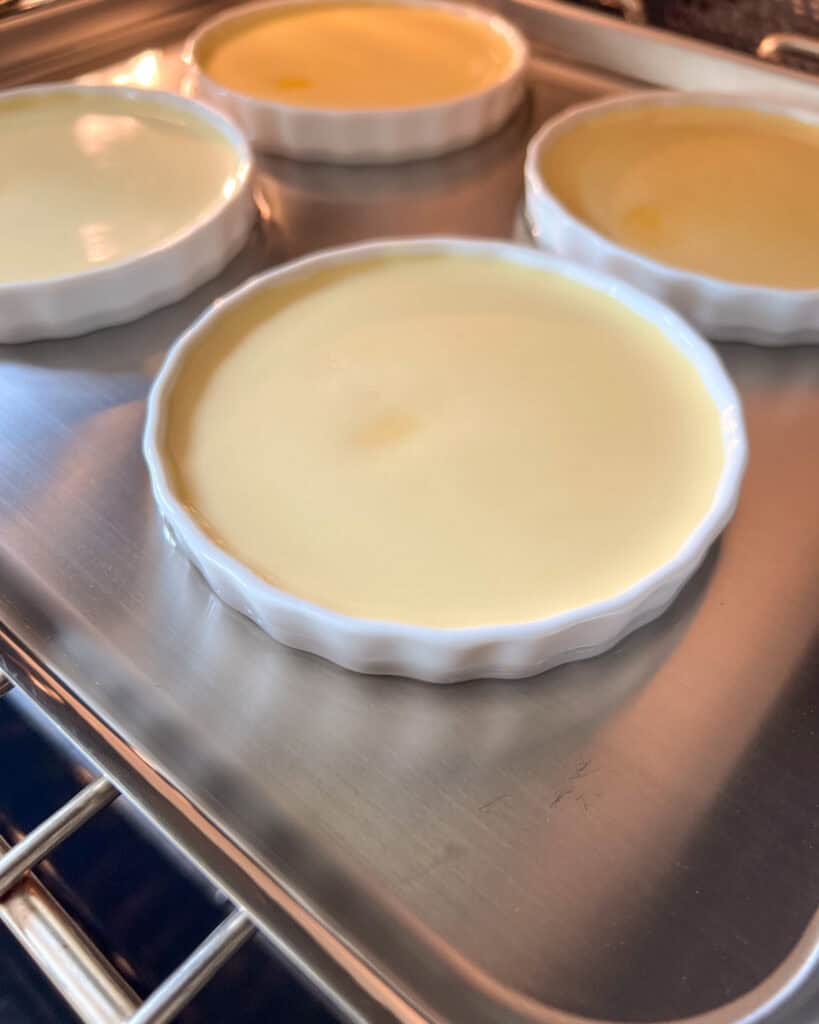 Carefully place the ramekins on a sheet pan, then fill the dish with boiling water halfway up the sides of the ramakins.