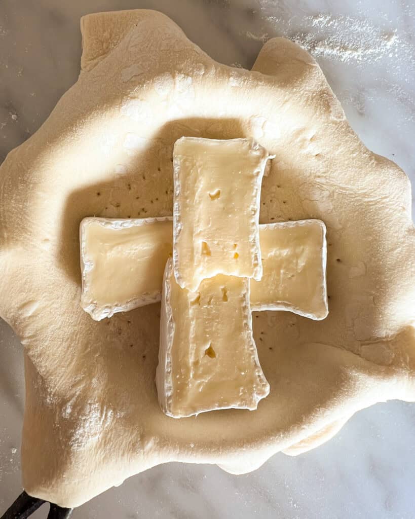 Four Brie wedges place in the center of the tart.