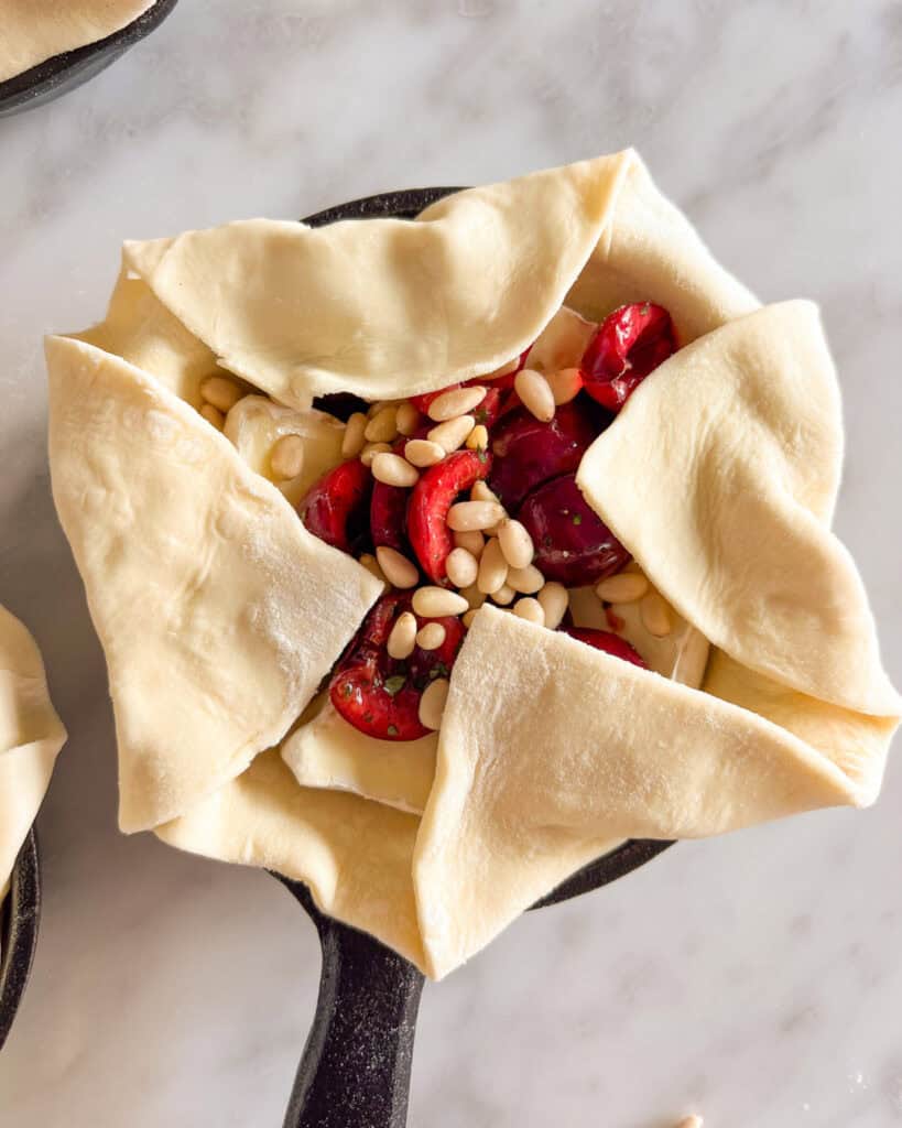 Gently fold over the corners of the pastry towards the center, leaving a rustic X in the middle.
