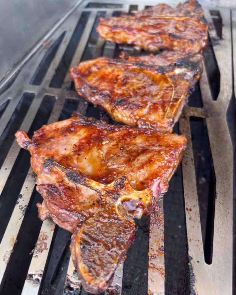 Three chops brushed with sauce.