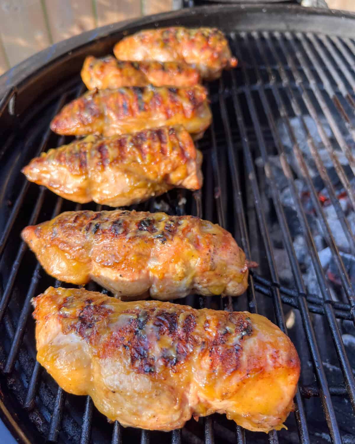 The sauced chicken still is cooking on the indirect side of the BBQ.
