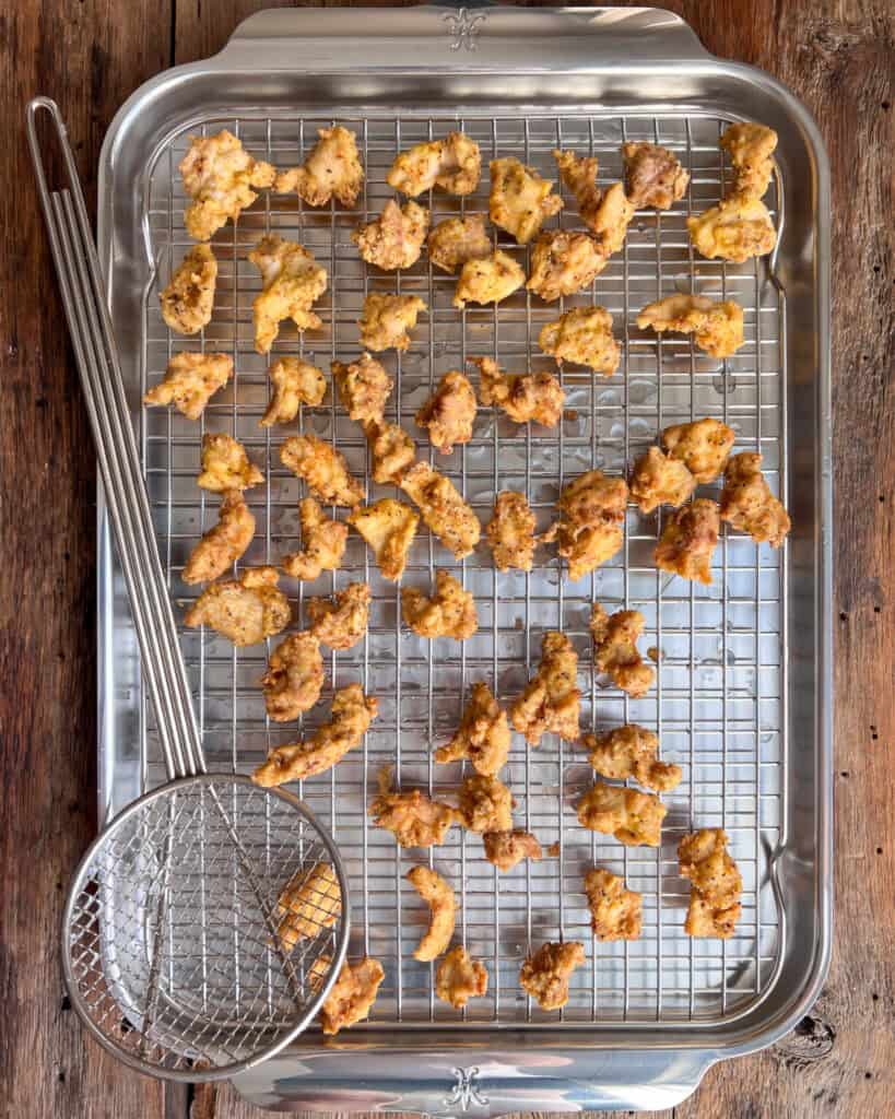 Place the chicken on a rack over a sheet pan to drain.