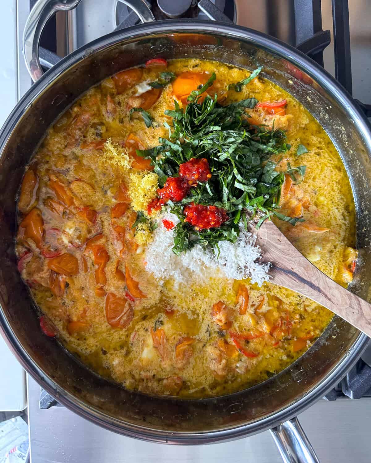 Add mascarpone, basil, chili oil & Parmesan, lemon zest lemon juice to the tomatoes.