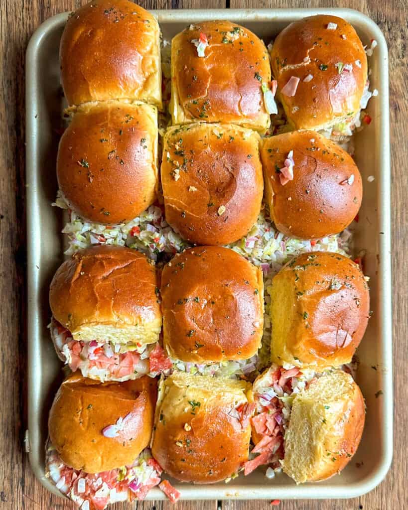A tray of chopped Italian Sliders cut into pieces.