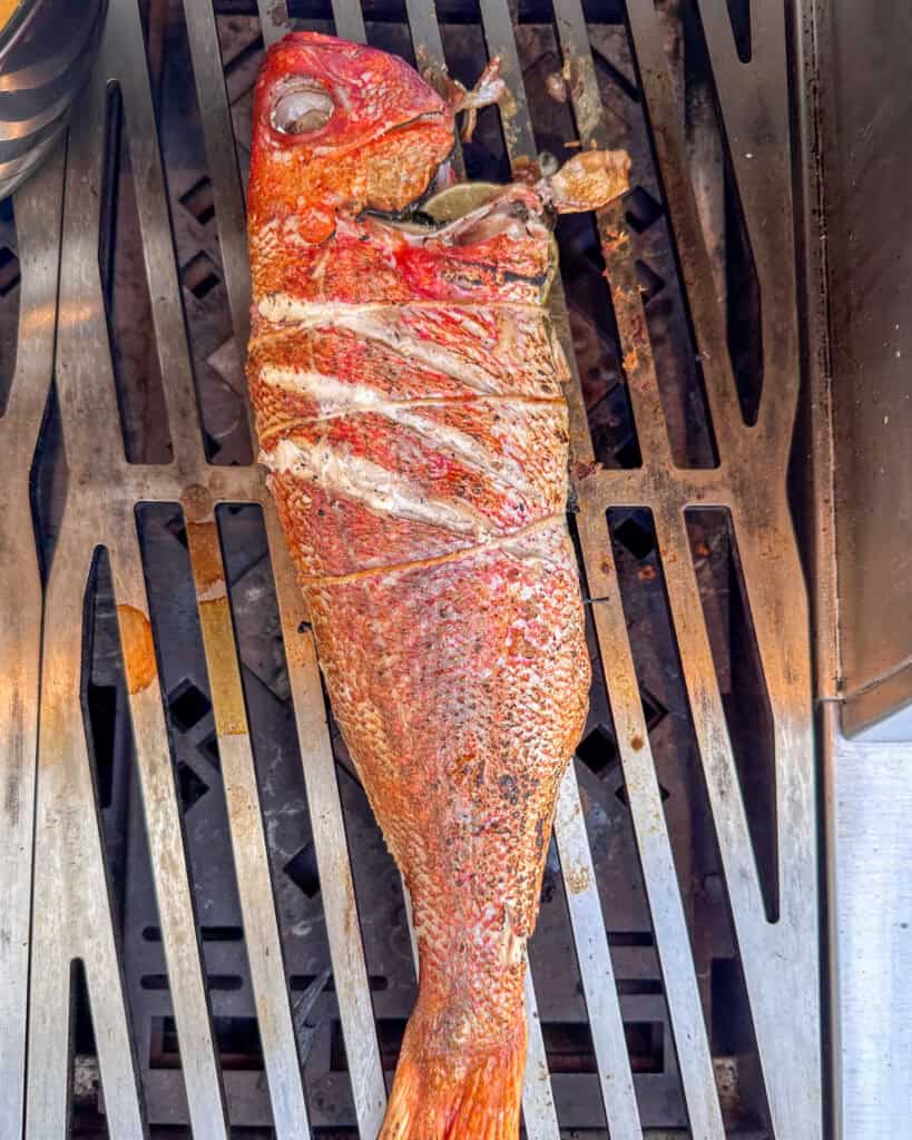 An image of cooking red snapper on grill.