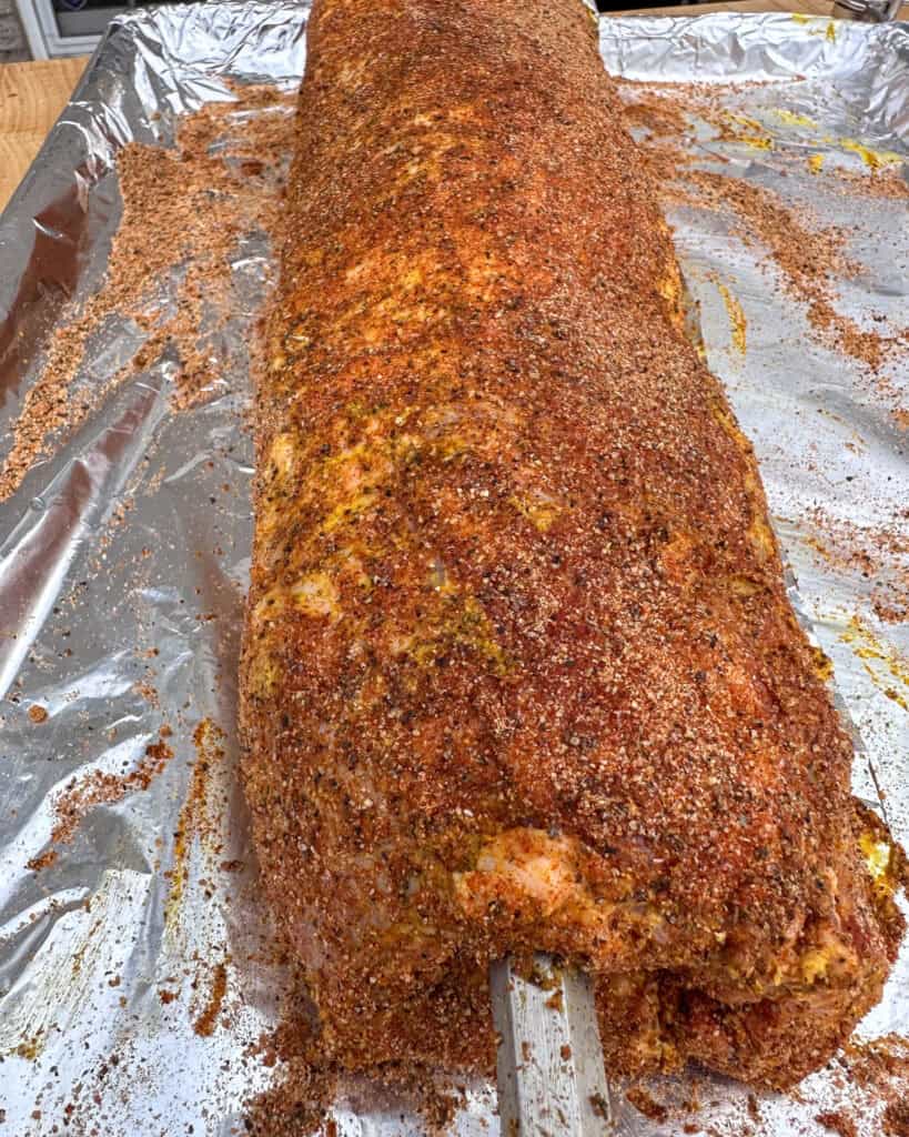 Spread dry rub all over the pork.