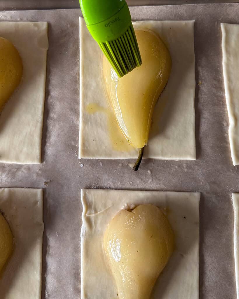 Brush the poaching liquid over the pears.