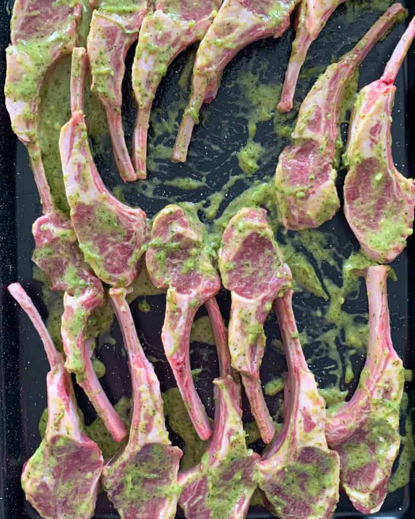 A tray of marinating lamb chops.