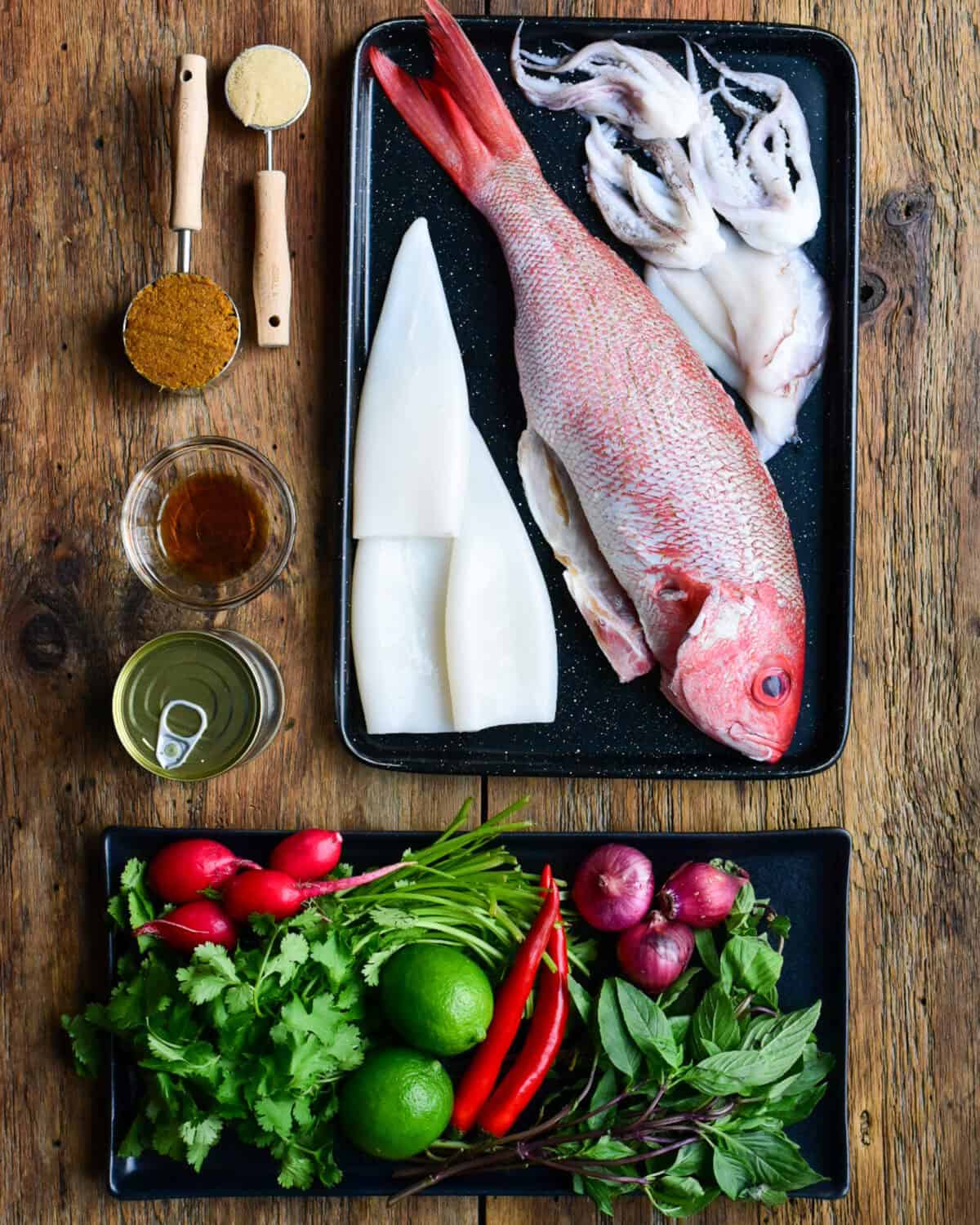 Ingredients laid out for a yellow curry red snapper recipe.
