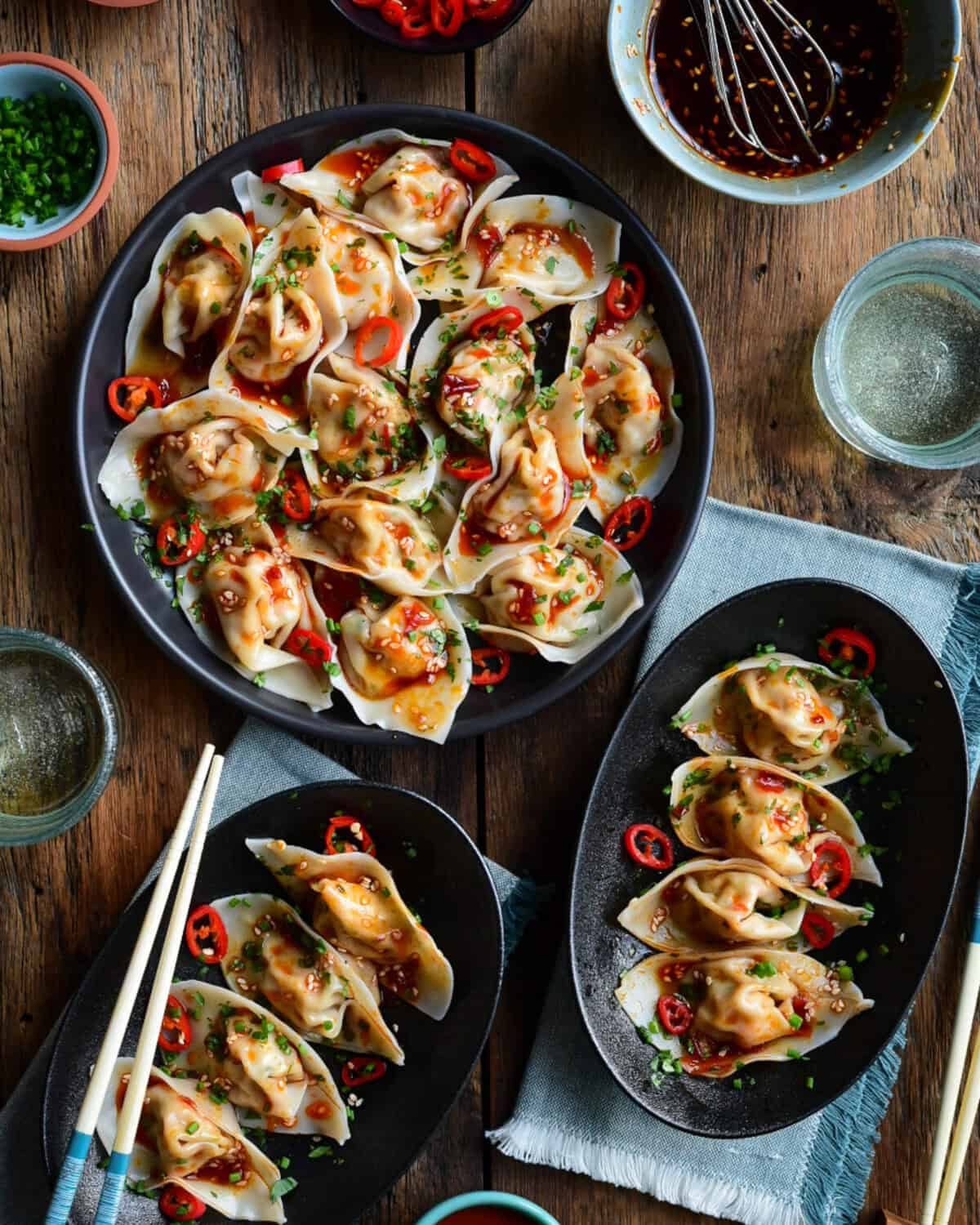 Shrimp Wontons with Spicy Sauce served four per plate with extra sauce on the side.