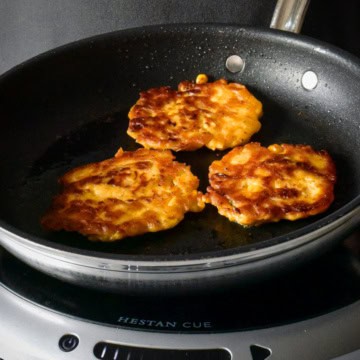 Three Kimchi Potato Pancakes in a skillet.