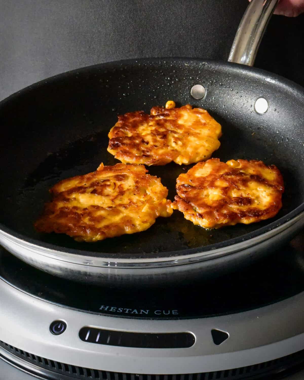 Three Kimchi Potato Pancakes in a skillet.