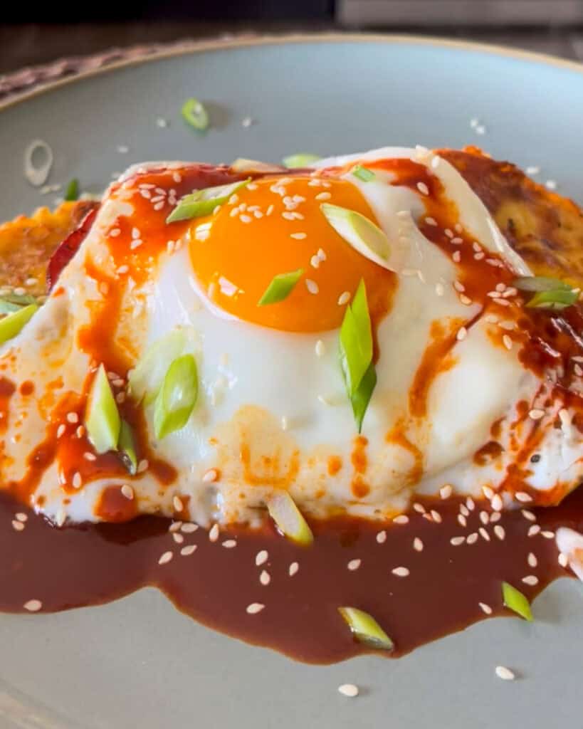An egg, bacon and kimchi potato pancake breakfast.