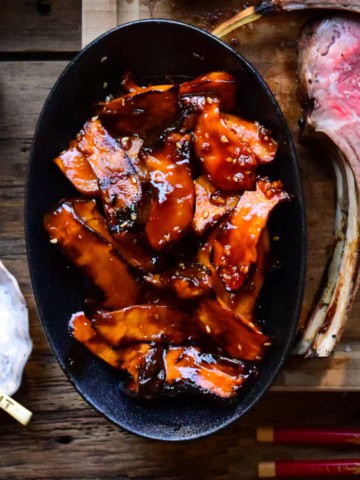 A bowl of grilled gochujang baby king oyster mushrooms.