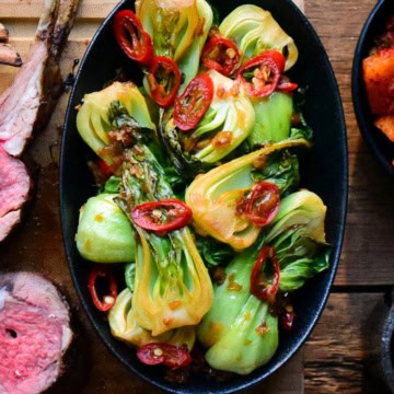 A small bowl of Ginger-Garlic Baby Bok Choy with red chilies.