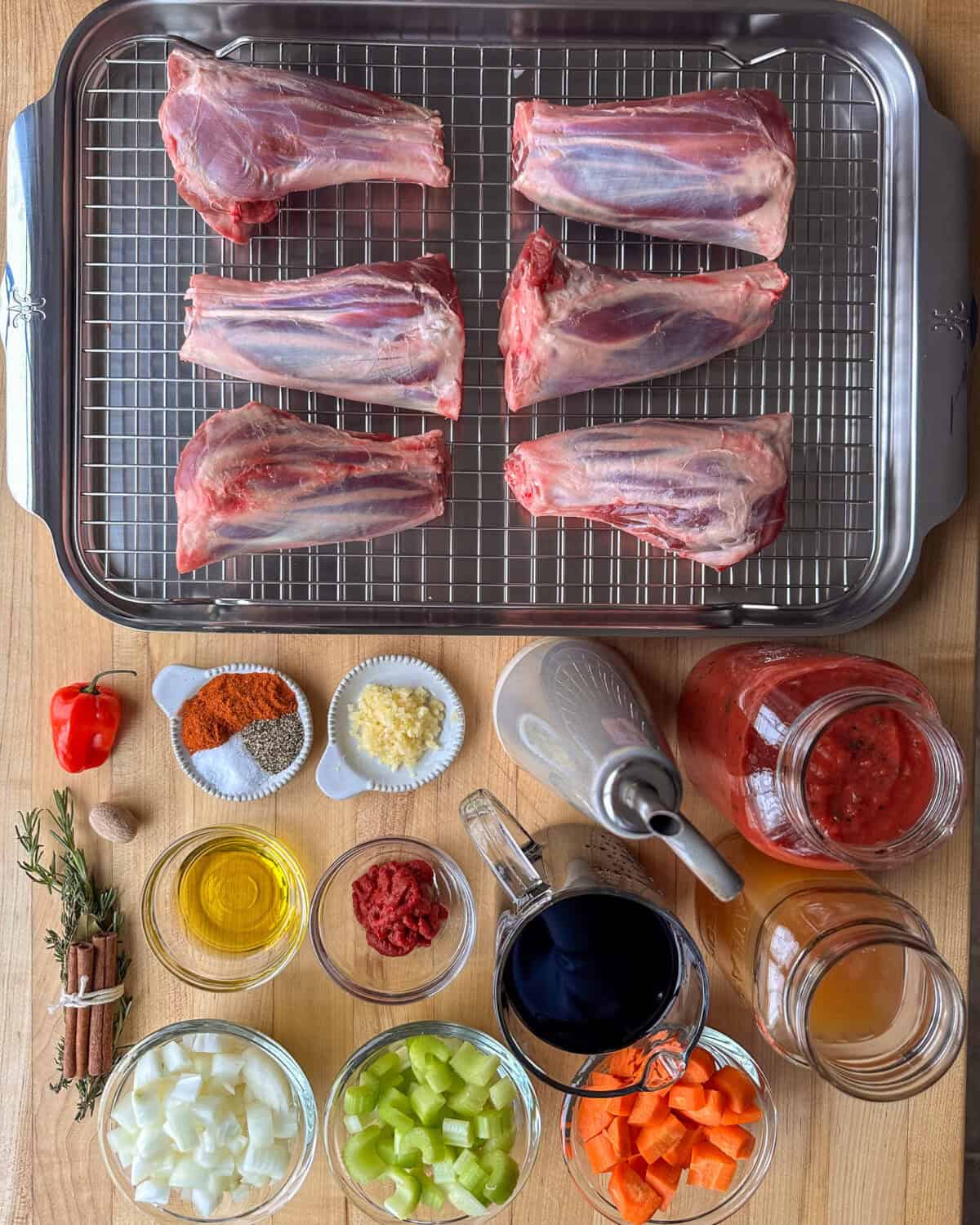 Ingredients laid out for a lamb shanks in tomato sauce recipe.