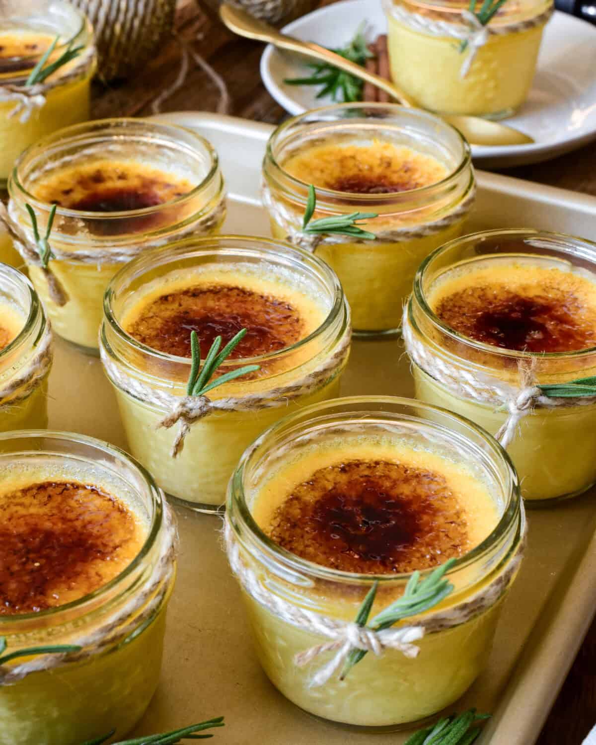 Several mini mason jars of Gingerbread creme brulee in mason jars.