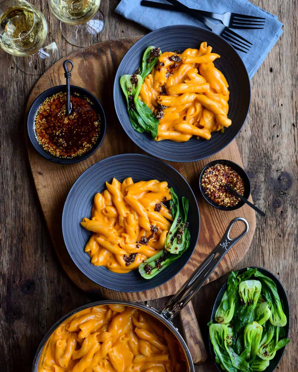 Serve the gochujang mac and cheese in a bowl with bok choy and add a drizzle of chili oil over the top.