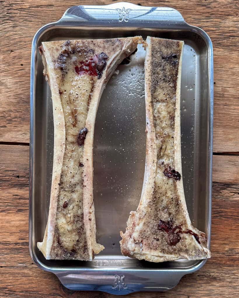 Two roasted canoe cut beef bone marrow bones.