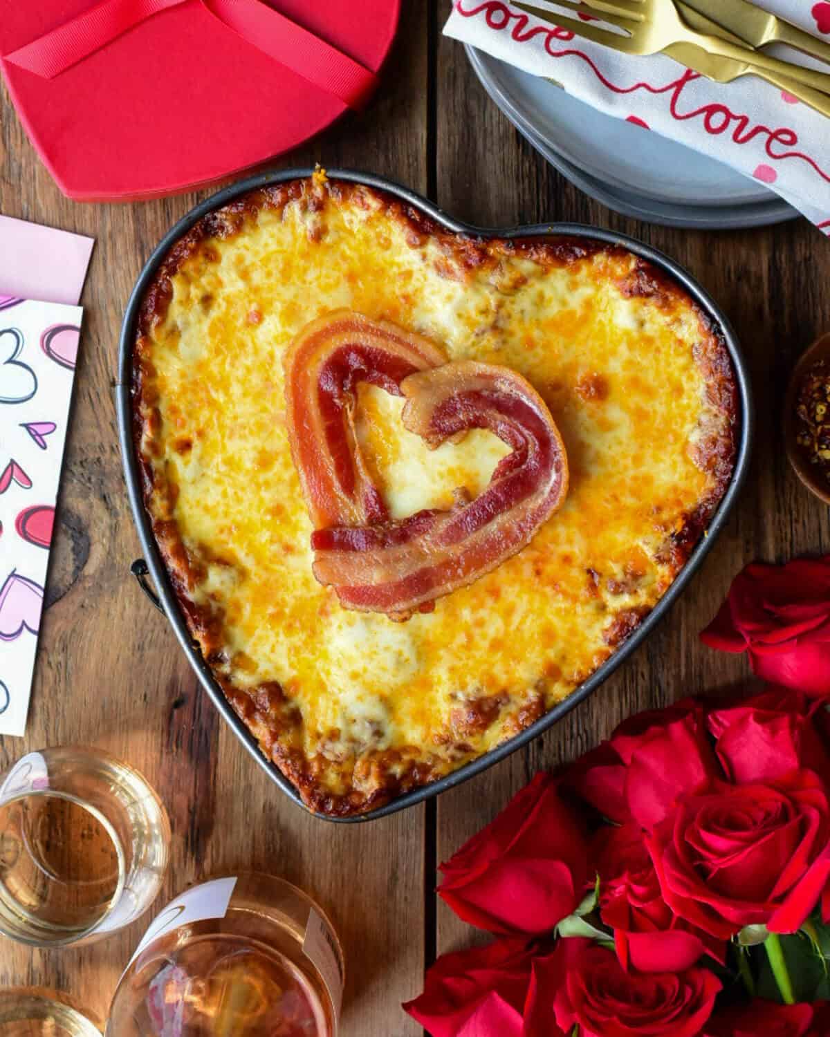 A heart shaped Lasagna with Bacon and Sausage in the filling and a bacon heart on the top.