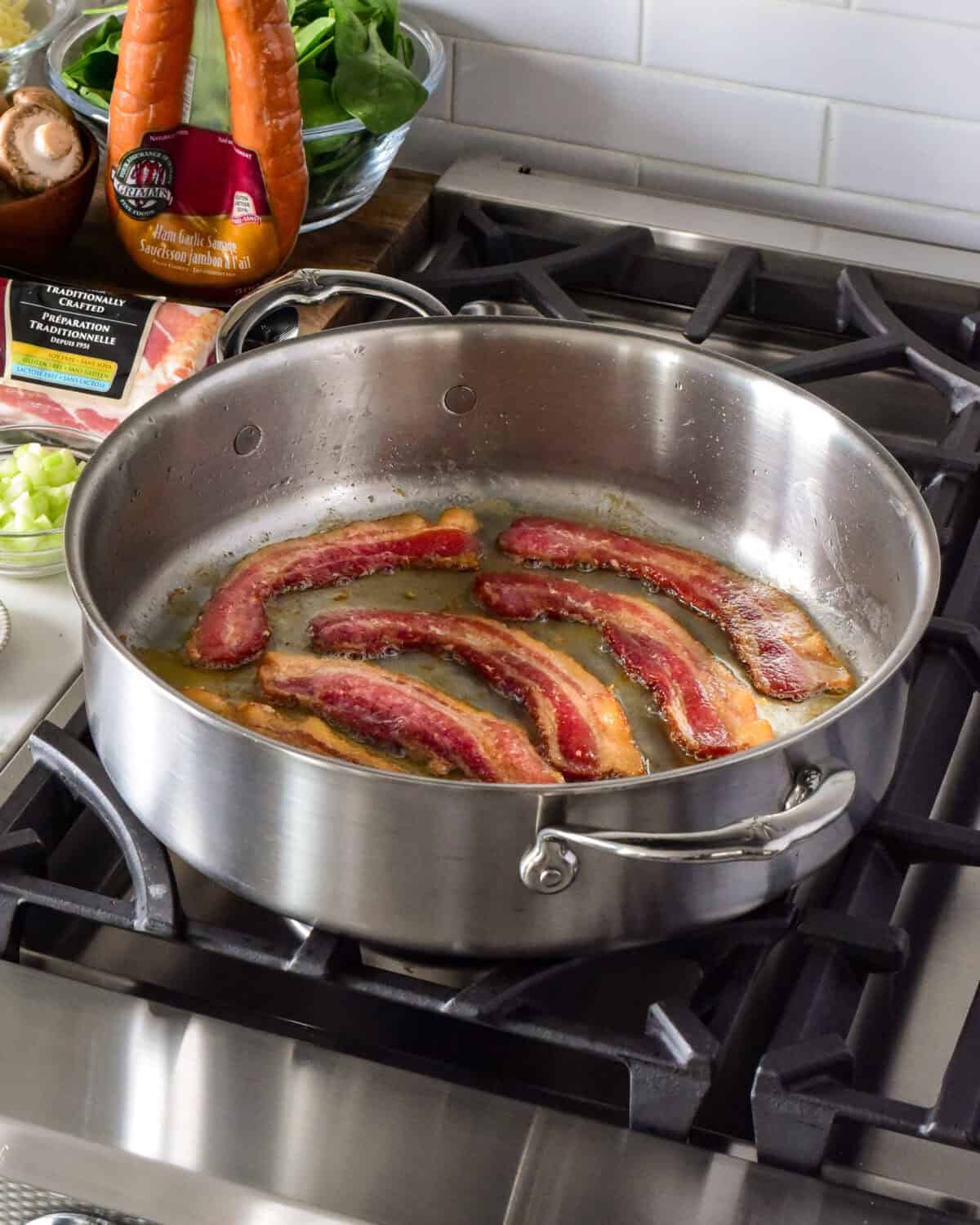Cook the bacon in a large pan.