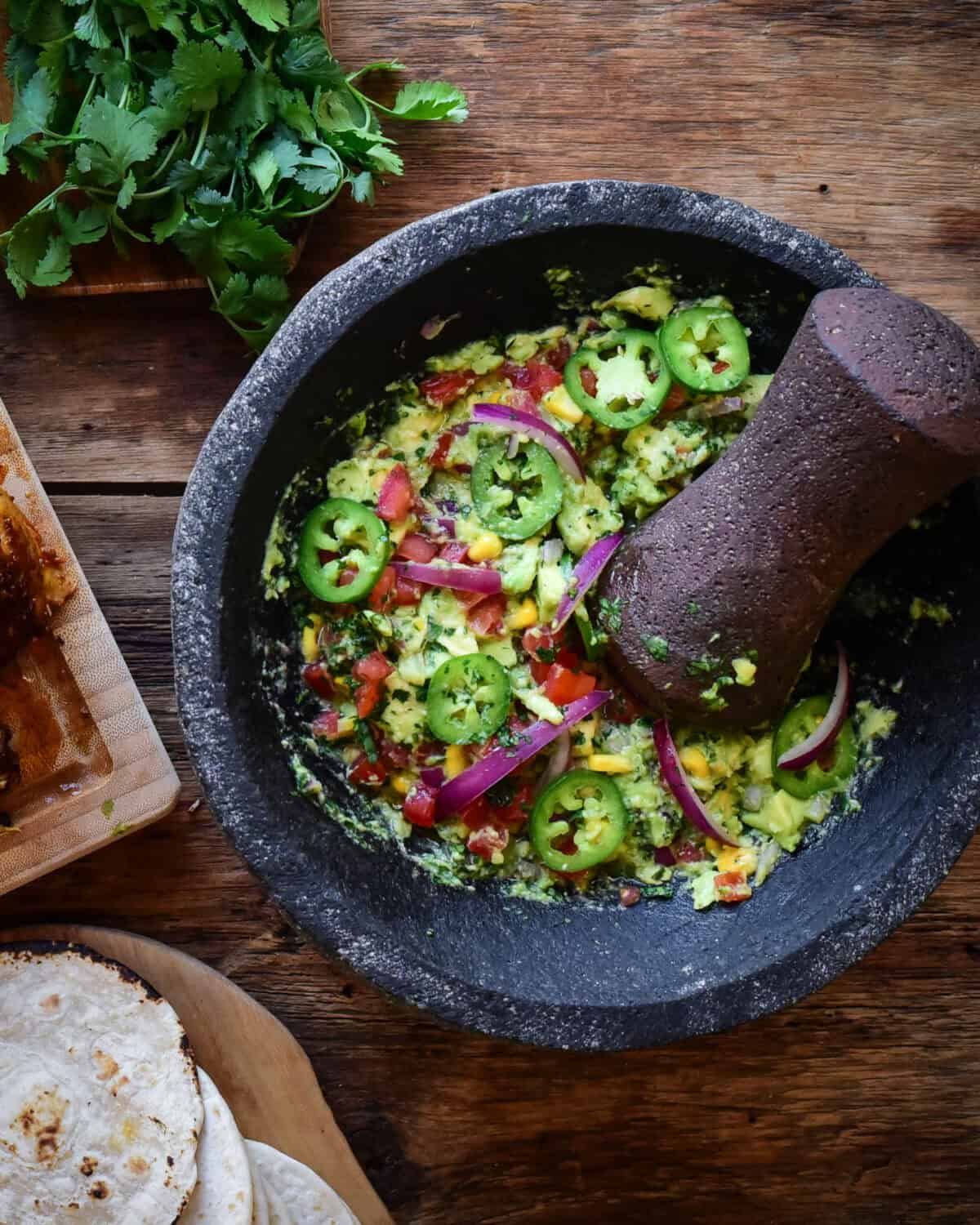 A large a molcajete filled with fresh guacamole.