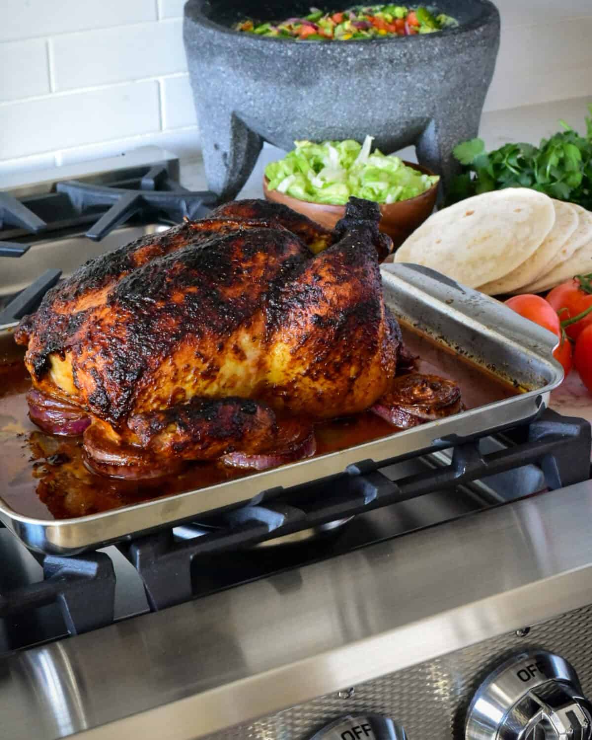 A roasted chicken out from the oven ready to make tacos.