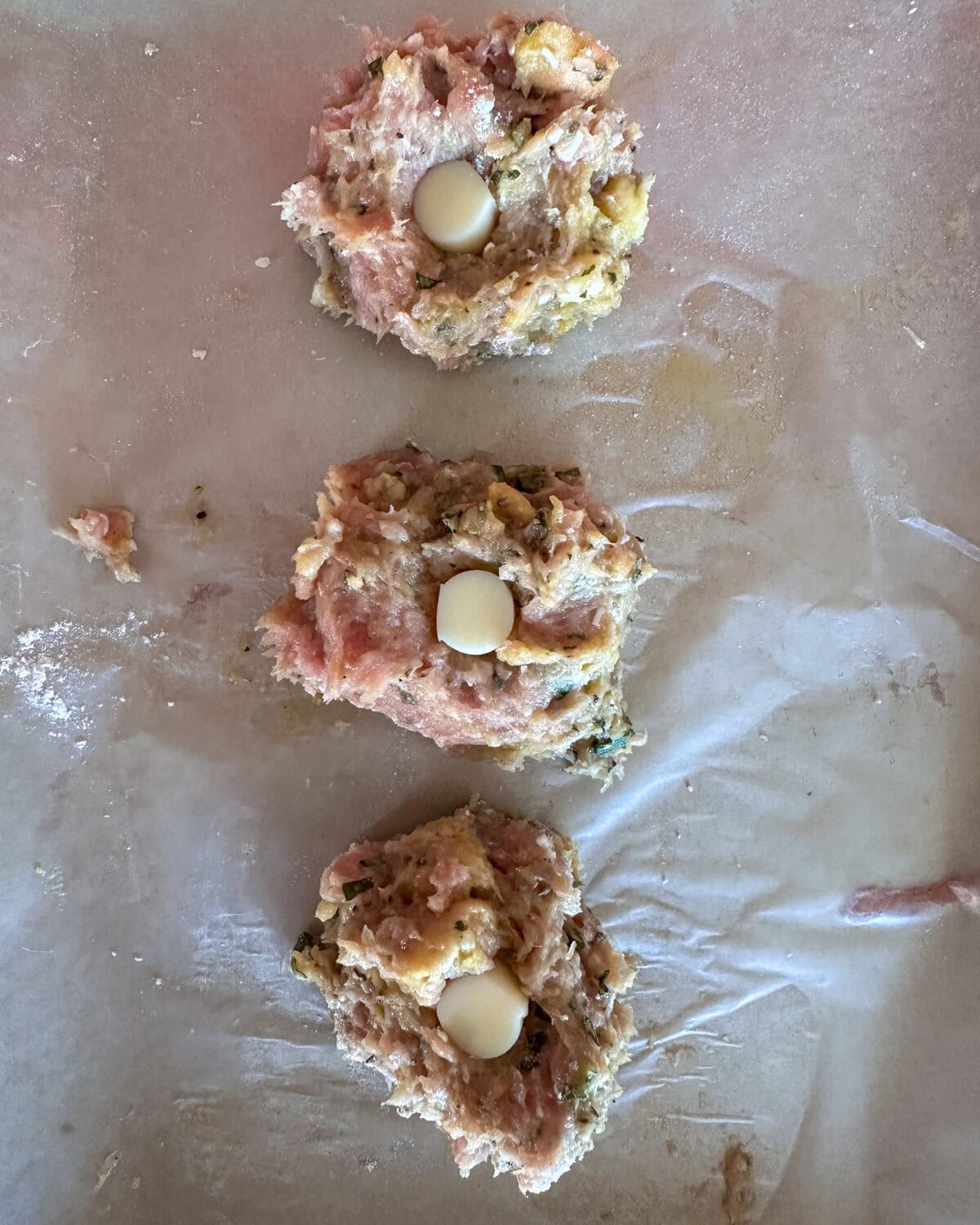 Add a piece of cheese into the center of the meatball.