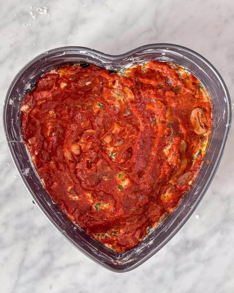 Assembling lasagna - meat sauce layer.