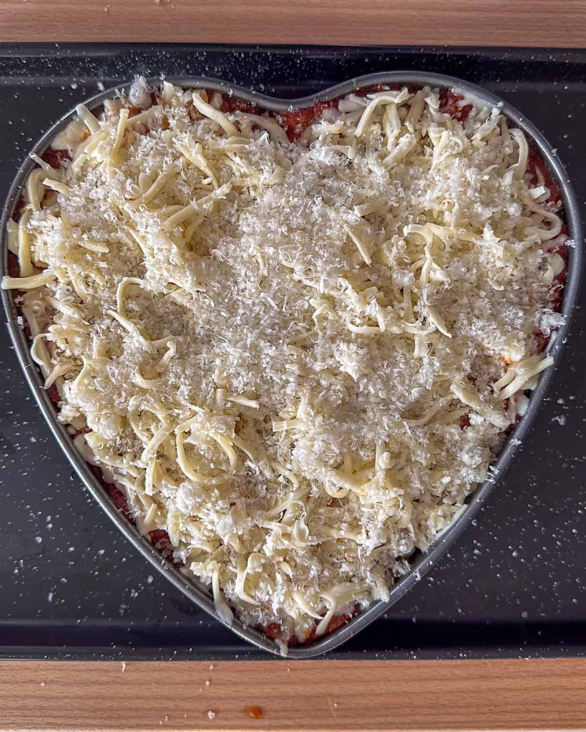 Remove the foil on the lasagna and sprinkle with the remaining 2 ½ cups mozzarella cheese and ½ cup Parmesan cheese. Bake for an additional 15 minutes or until browned and bubbly.