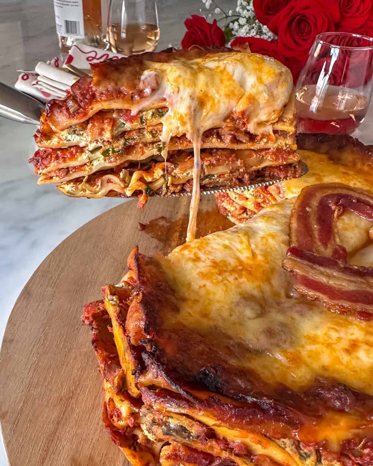 A cut piece of lasagna showing the layers and oozy cheese.