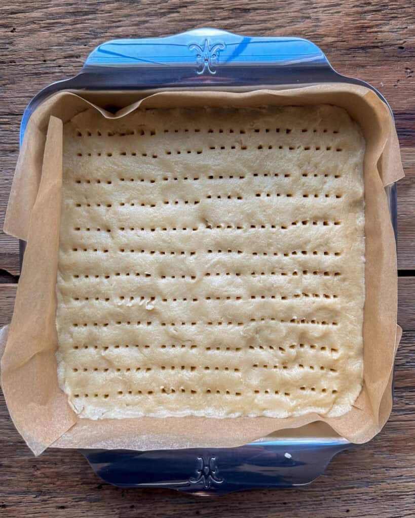 Prick the shortbread with the tines of a fork, creating rows.