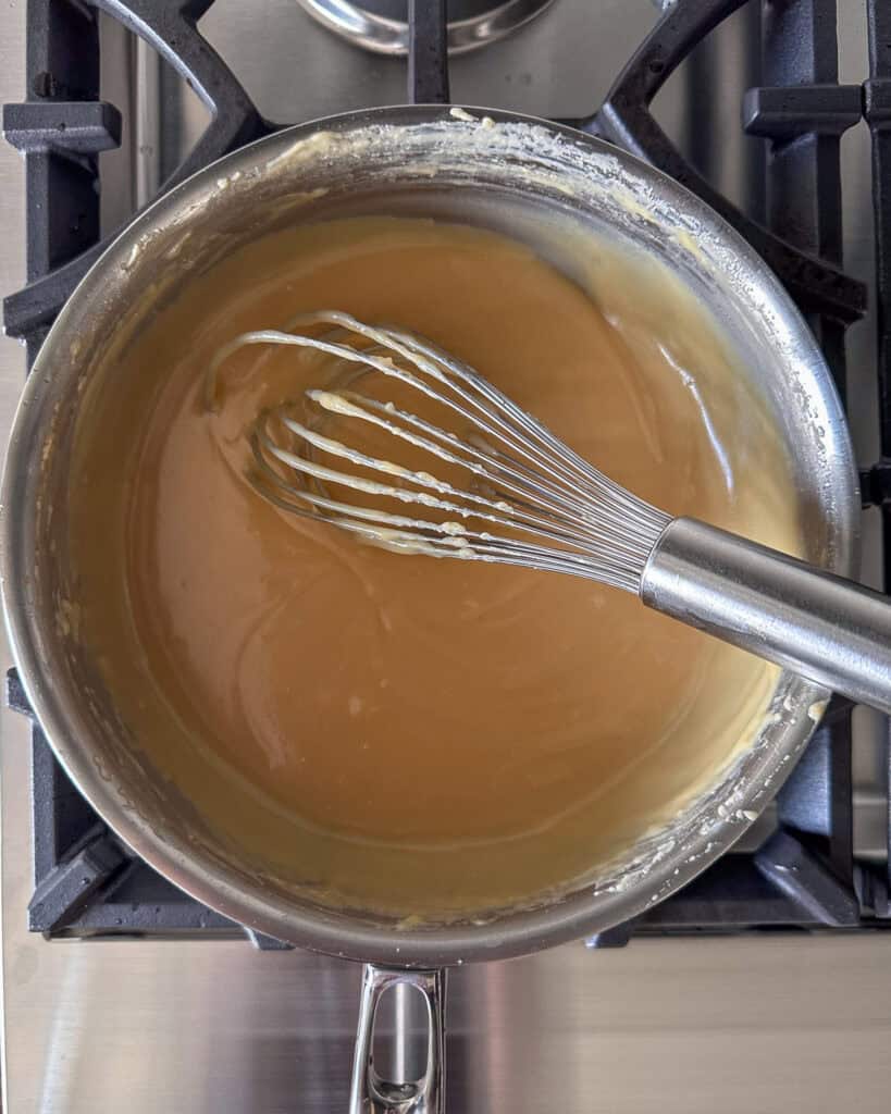 Simmer until the dulce de leche has thickened and is golden, stirring constantly.