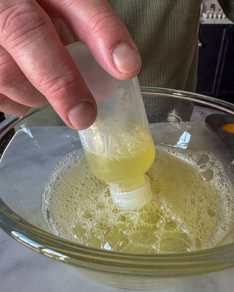 Using a plastic squeeze bottle as a syringe, is an easy way to fill the egg whites into the muffin cups.