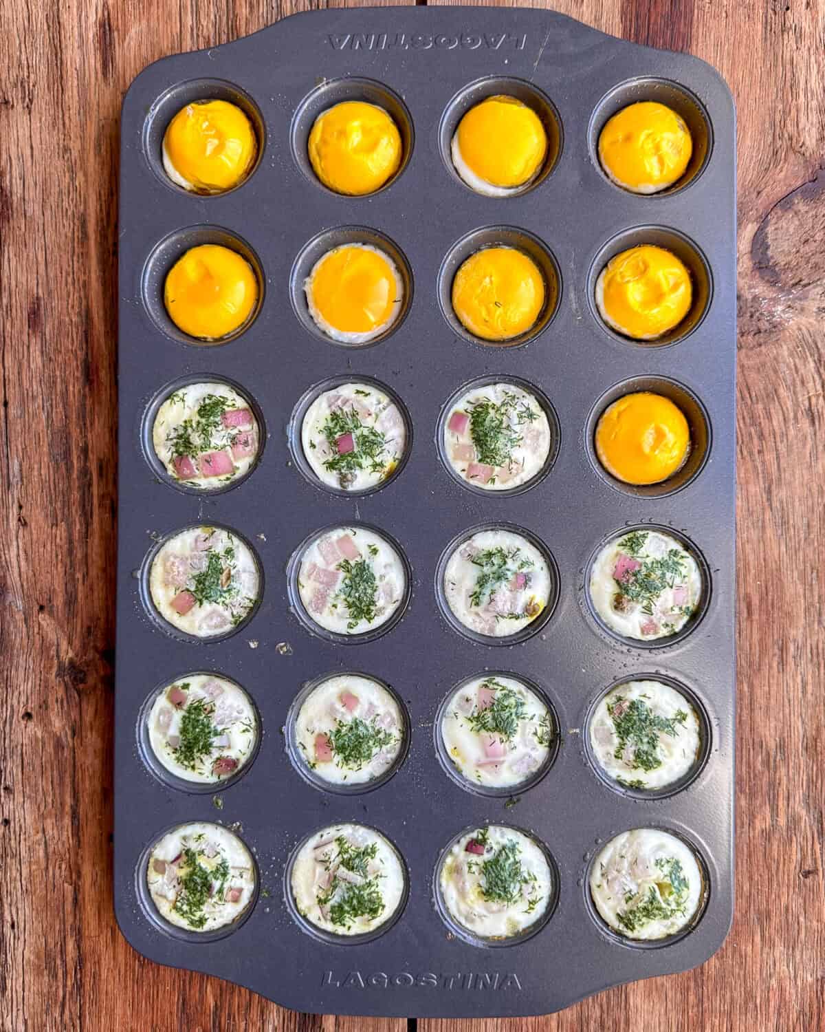 Baked egg whites and yolks separated in a muffin tin for deviled eggs.