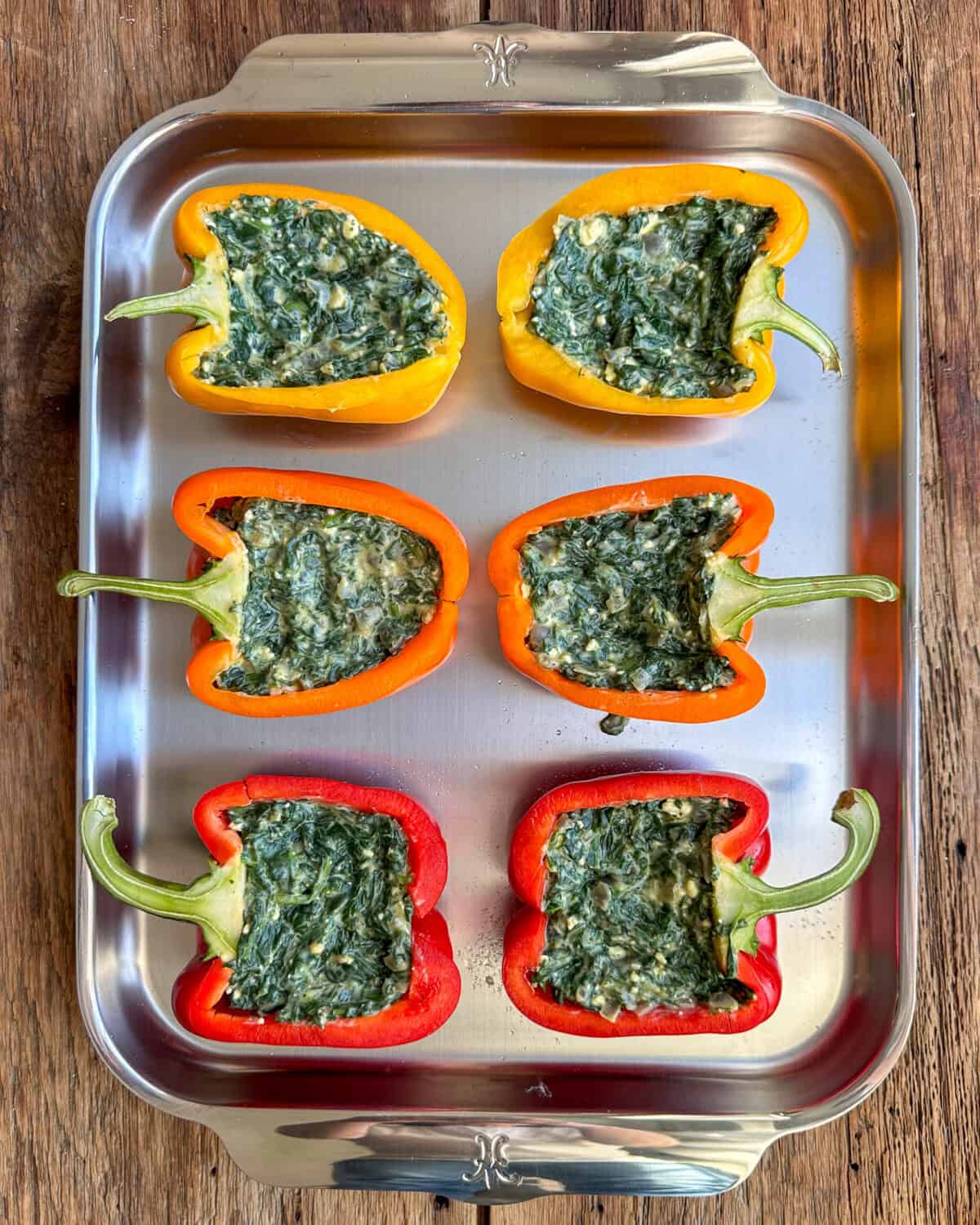 Add the spinach mixture evenly into the six pepper halves.