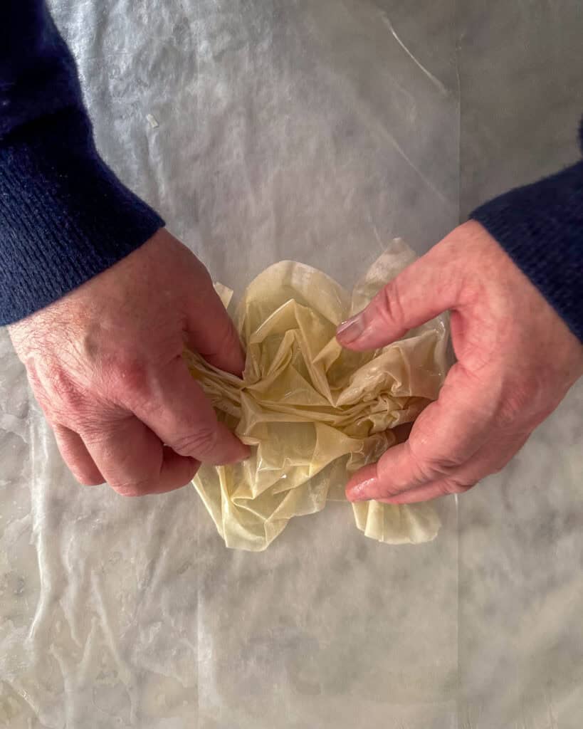 Step 3: Continue to loosely scrunch until you reach the end of the sheet.