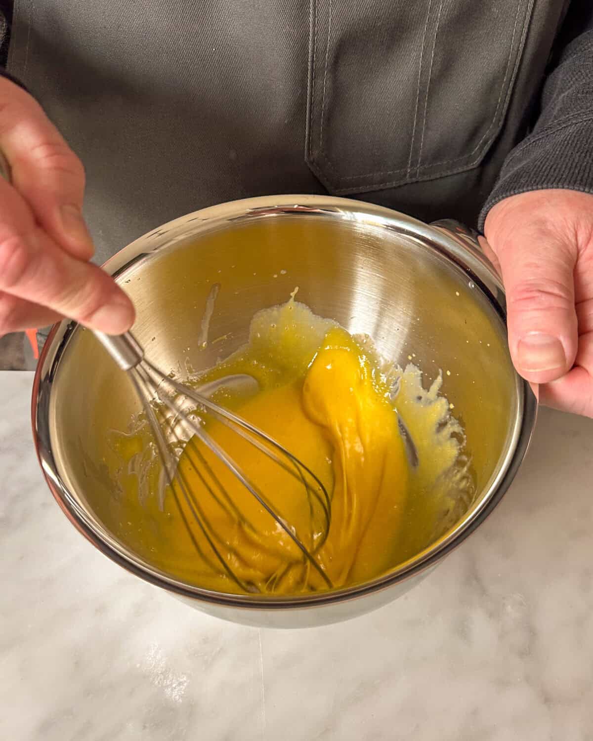 In the mixing bowl, vigorously whisk together the egg yolks, lemon juice and mustard until frothy and thickened.