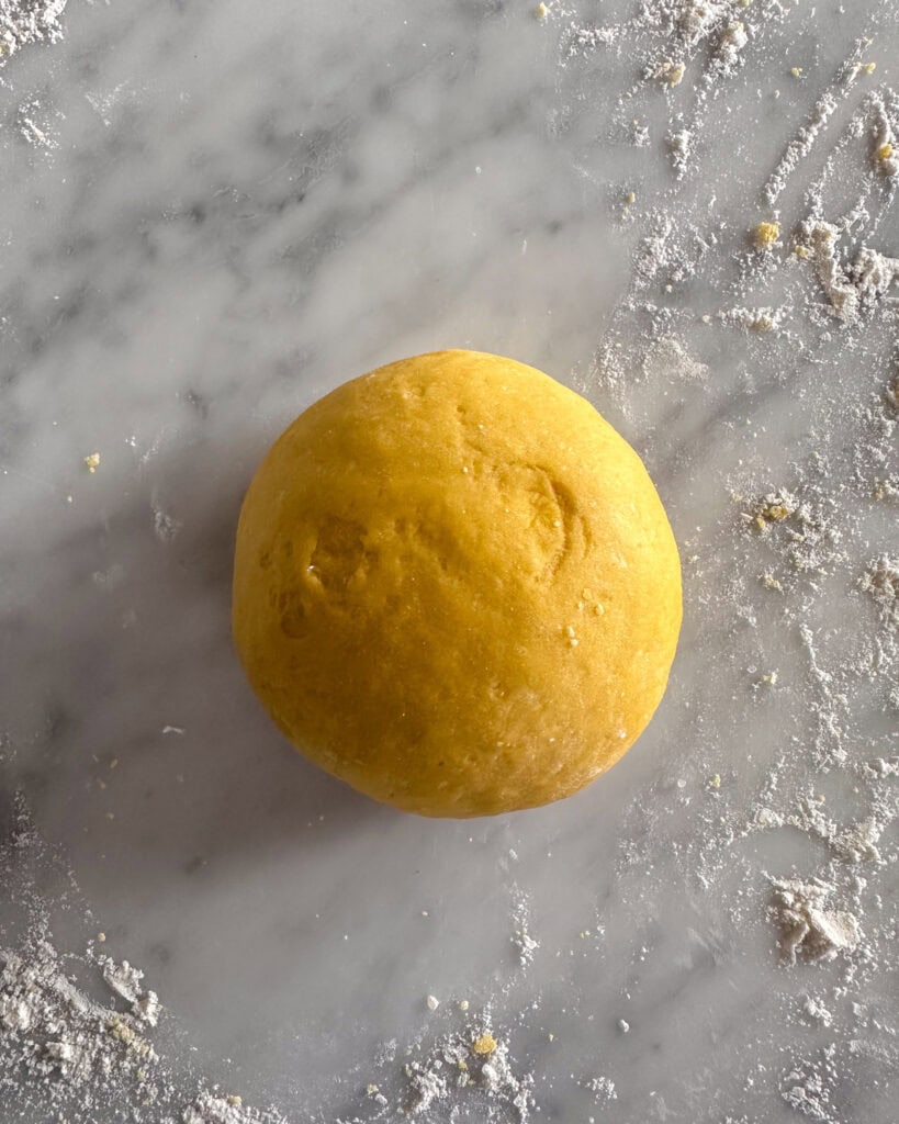 Knead the dough on a lightly floured surface for about 8-10 minutes until smooth and elastic.