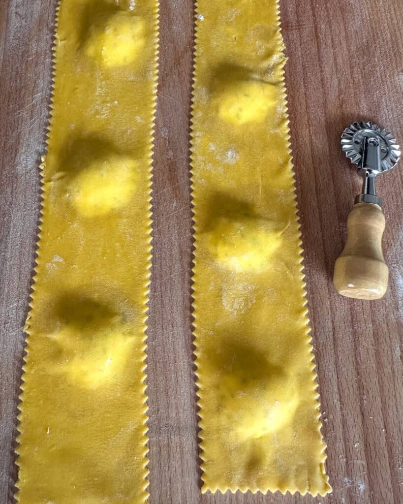 Use a fluted pastry wheel (or a knife or pasta cutter) to cut the ravioli into individual squares (or circles.)